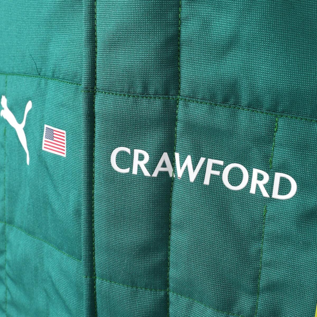 Crawford name and United States flag detail on the 2026 Aston Martin F1 race suit – Trending Racegear.